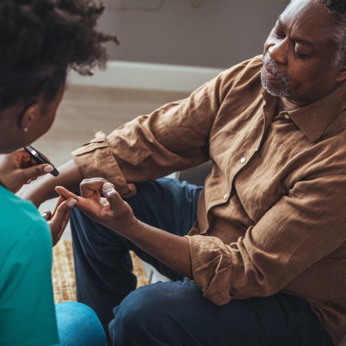 Female,Healthcare,Worker,Holding,Hands,Of,Senior,Man,At,Care